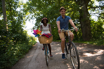 Image showing Young multiethnic couple having a bike ride in nature