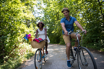 Image showing Young multiethnic couple having a bike ride in nature