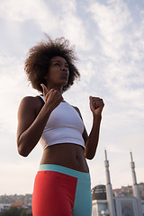 Image showing Portrait of sporty young african american woman running outdoors