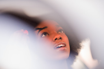 Image showing a young African-American woman makeup in the car