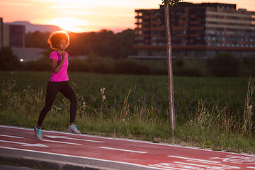 Image showing a young African American woman jogging outdoors