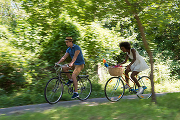 Image showing Young multiethnic couple having a bike ride in nature