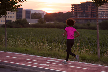 Image showing a young African American woman jogging outdoors