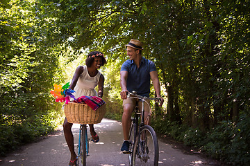 Image showing Young multiethnic couple having a bike ride in nature