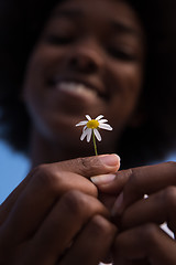 Image showing portrait of African American girl with a flower in her hand