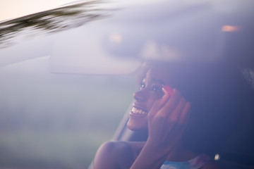 Image showing a young African-American woman makeup in the car