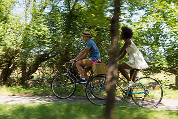 Image showing Young multiethnic couple having a bike ride in nature