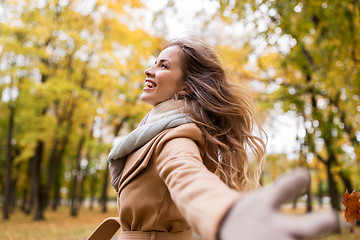 Image showing beautiful happy young woman walking in autumn park