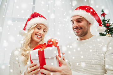 Image showing happy couple at home with christmas gift box