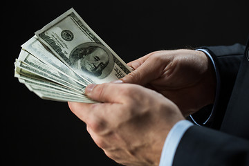 Image showing close up of businessman hands holding money