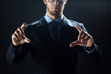 Image showing close up of businessman touching virtual screen