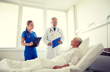 Image showing doctor and nurse visiting senior woman at hospital