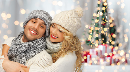 Image showing happy family couple in winter clothes hugging