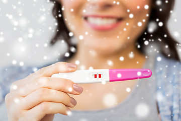 Image showing close up of happy woman with home pregnancy test