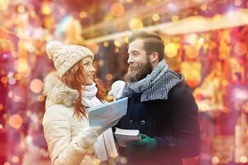 Image showing happy couple with map and city guide in old town