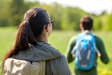 Image showing close up of couple with backpacks hiking outdoors