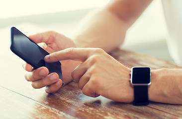 Image showing close up of hands with smart phone and watch