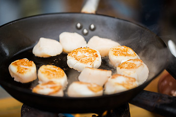 Image showing close up of scallops frying in cast iron pan