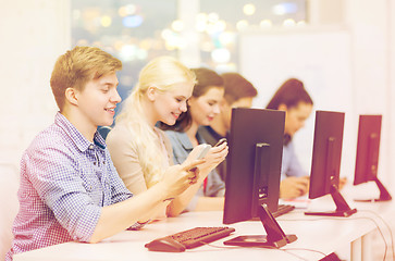 Image showing students with computer monitor and smartphones