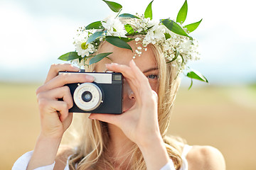 Image showing happy woman with film camera in wreath of flowers