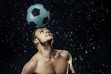 Image showing Water drops around football player