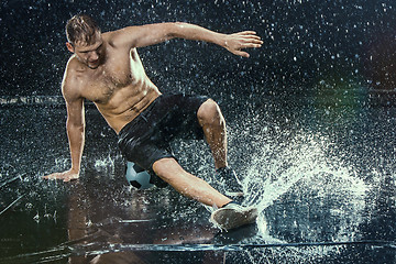 Image showing Water drops around football player