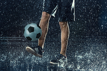 Image showing Water drops around football player