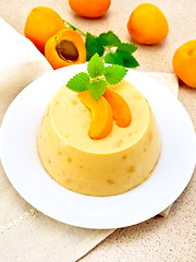 Image showing Panna cotta apricot with fruit on table