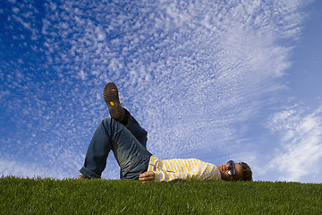 Image showing Young man lying down on the grass