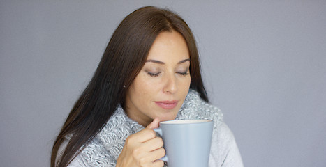 Image showing Beautiful brunette woman with a cup of hot drink