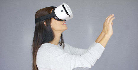 Image showing Adorable woman working with virtual reality glasses