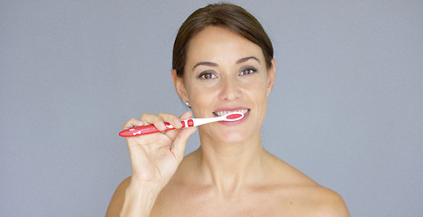 Image showing Healthy young woman cleaning her teeth