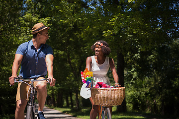 Image showing Young multiethnic couple having a bike ride in nature