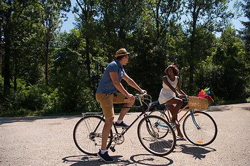 Image showing Young multiethnic couple having a bike ride in nature