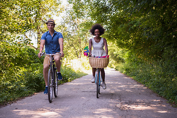 Image showing Young multiethnic couple having a bike ride in nature