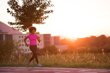 Image showing a young African American woman jogging outdoors