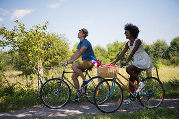 Image showing Young multiethnic couple having a bike ride in nature