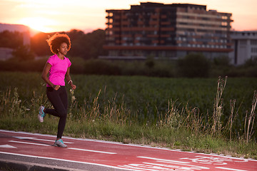 Image showing a young African American woman jogging outdoors