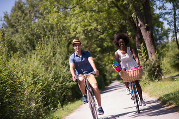 Image showing Young multiethnic couple having a bike ride in nature