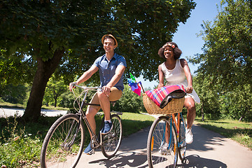 Image showing Young multiethnic couple having a bike ride in nature