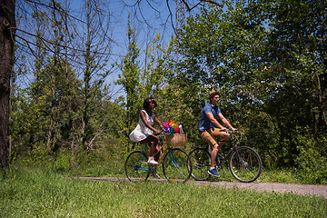 Image showing Young multiethnic couple having a bike ride in nature