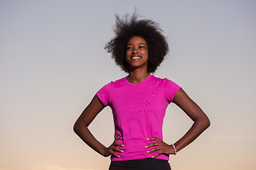 Image showing Portrait of a young african american woman running outdoors