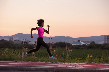 Image showing a young African American woman jogging outdoors