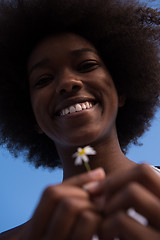 Image showing portrait of African American girl with a flower in her hand