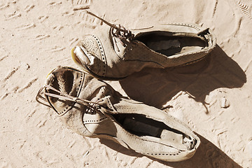 Image showing old pair of shoes on sand