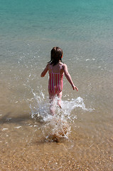 Image showing Girl running into the water