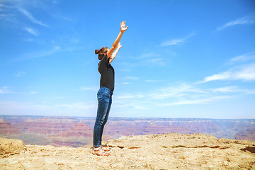 Image showing Young lady at the edge of the Grand Canyon rim