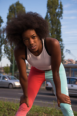 Image showing Portrait of sporty young african american woman running outdoors