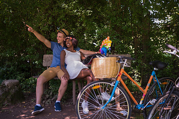 Image showing Young multiethnic couple having a bike ride in nature