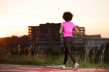 Image showing a young African American woman jogging outdoors